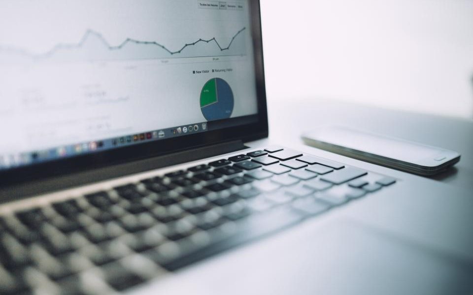 Website traffic and analytics charts open on a laptop